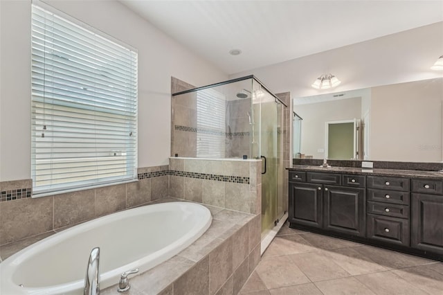 6706 Riverside Bluffs Dr, Riverview, FL 33578 - bathroom featuring double vanity, a garden tub, a stall shower, and tile patterned flooring