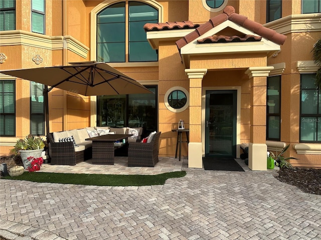 2741 Via Cipriani Unit 916A, Clearwater, FL 33764 - entrance to property with an outdoor living space, a patio, and stucco siding