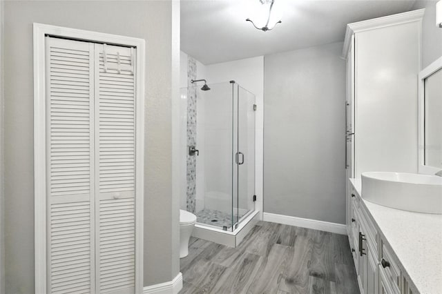 2741 Via Cipriani Unit 916A, Clearwater, FL 33764 - bathroom with a closet, a shower stall, vanity, and wood finished floors