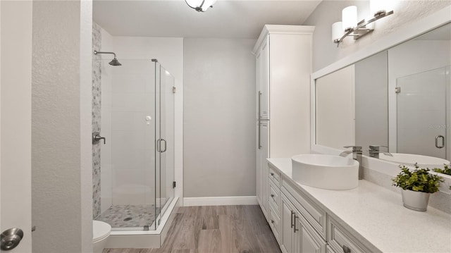 2741 Via Cipriani Unit 916A, Clearwater, FL 33764 - bathroom with a shower stall, vanity, and wood finished floors