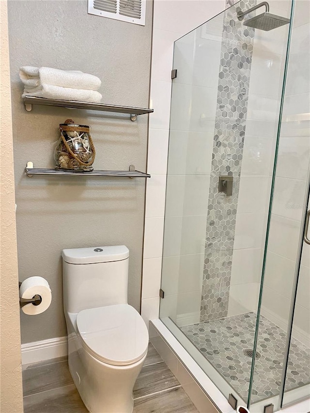 2741 Via Cipriani Unit 916A, Clearwater, FL 33764 - full bathroom featuring wood finished floors and a shower stall