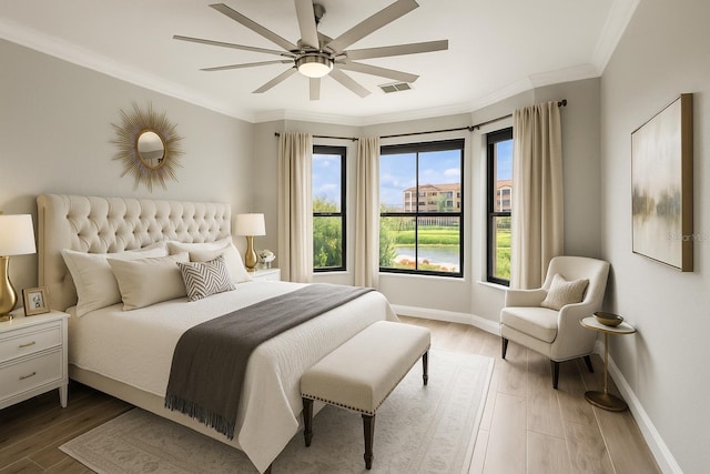 2741 Via Cipriani Unit 916A, Clearwater, FL 33764 - bedroom with multiple windows, ornamental molding, wood finished floors, and ceiling fan