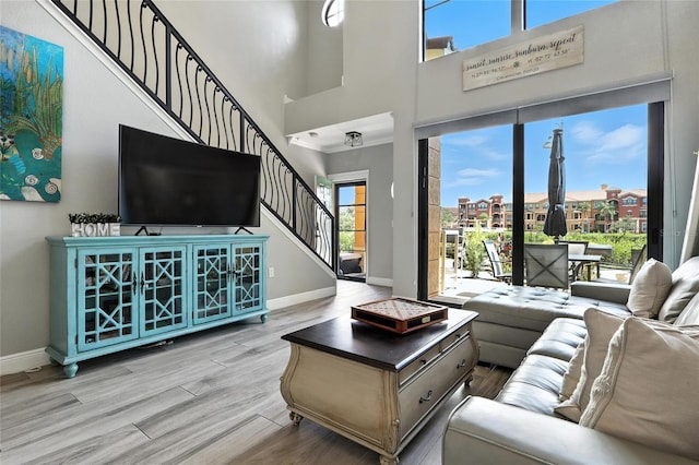 2741 Via Cipriani Unit 916A, Clearwater, FL 33764 - living room with stairway, wood finished floors, and a towering ceiling