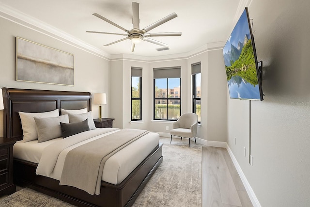 2741 Via Cipriani Unit 916A, Clearwater, FL 33764 - bedroom with wood finished floors, crown molding, and ceiling fan