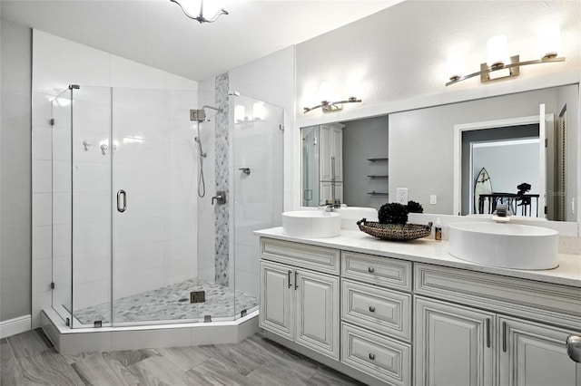 2741 Via Cipriani Unit 916A, Clearwater, FL 33764 - full bathroom featuring a stall shower, double vanity, and vaulted ceiling