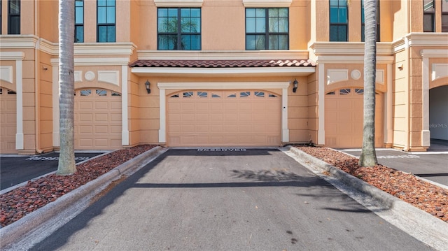 2741 Via Cipriani Unit 916A, Clearwater, FL 33764 - view of front of home featuring a garage and stucco siding