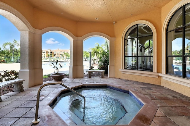 2741 Via Cipriani Unit 916A, Clearwater, FL 33764 - view of pool featuring a community hot tub and a patio