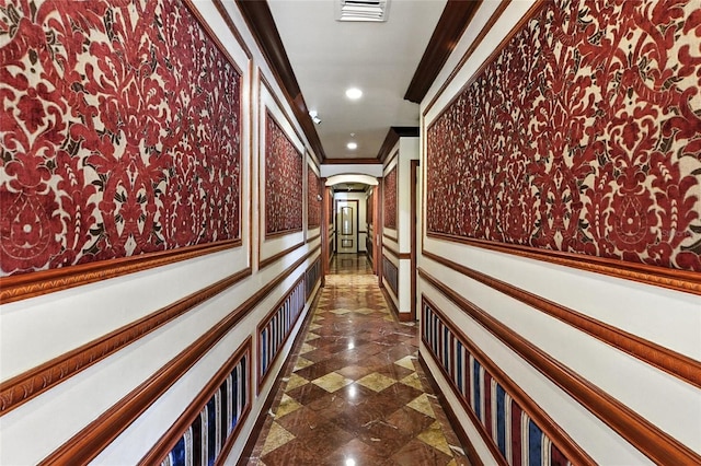 2741 Via Cipriani Unit 916A, Clearwater, FL 33764 - hallway featuring a wainscoted wall, crown molding, wallpapered walls, recessed lighting, and ornate columns