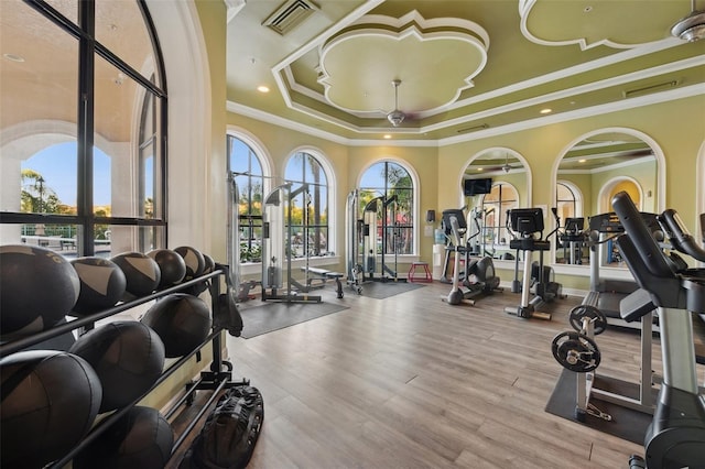 2741 Via Cipriani Unit 916A, Clearwater, FL 33764 - workout area featuring a tray ceiling, ornamental molding, wood finished floors, and recessed lighting