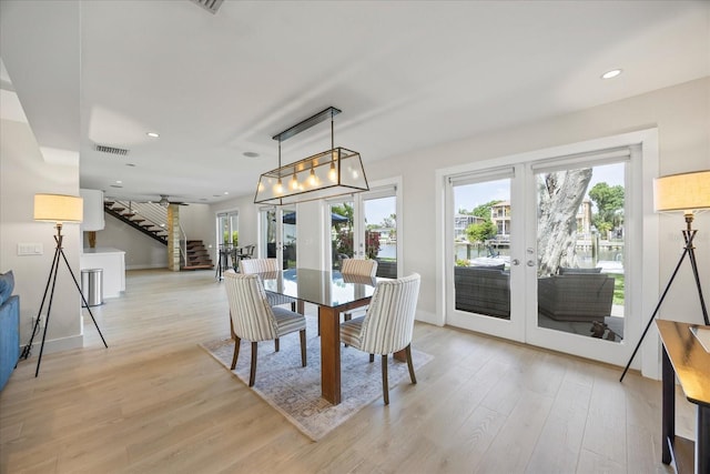 3956 Versailles Dr, Tampa, FL 33634 - dining space featuring french doors, stairway, light wood-style floors, and recessed lighting