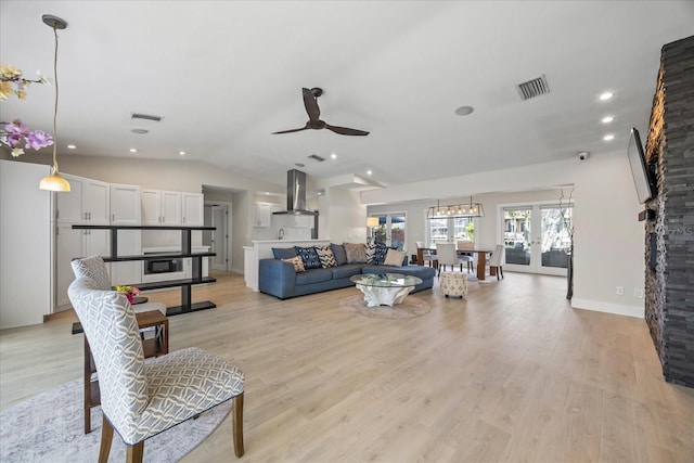 3956 Versailles Dr, Tampa, FL 33634 - living room featuring light wood-type flooring, ceiling fan, lofted ceiling, and recessed lighting