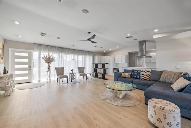 3956 Versailles Dr, Tampa, FL 33634 - living room with ceiling fan, light wood-type flooring, lofted ceiling, and recessed lighting
