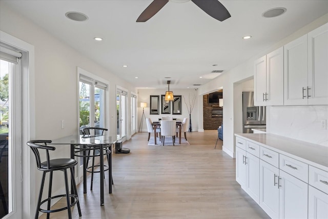3956 Versailles Dr, Tampa, FL 33634 - dining area with a ceiling fan, light wood-style flooring, and recessed lighting