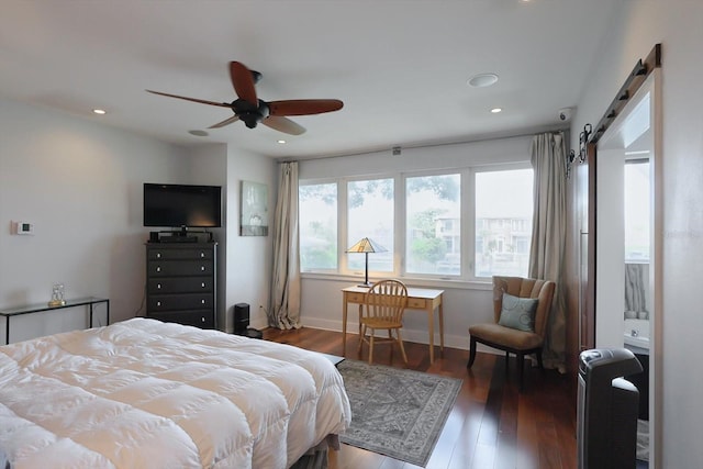 3956 Versailles Dr, Tampa, FL 33634 - bedroom with a barn door, wood finished floors, recessed lighting, and ceiling fan