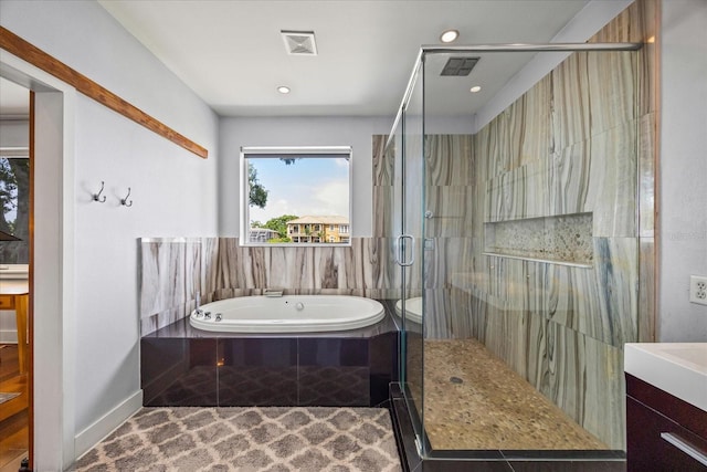 3956 Versailles Dr, Tampa, FL 33634 - bathroom featuring vanity, a bath, a stall shower, and recessed lighting