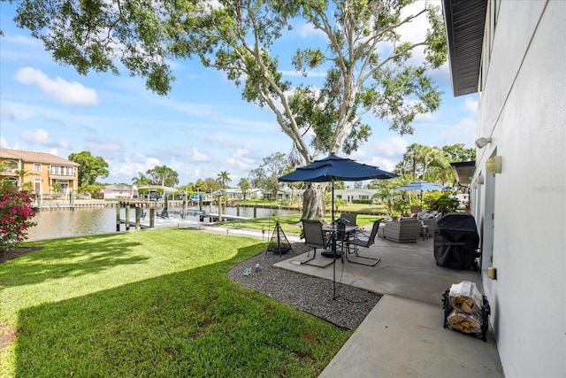 3956 Versailles Dr, Tampa, FL 33634 - view of green lawn featuring a water view, a patio, and a boat dock