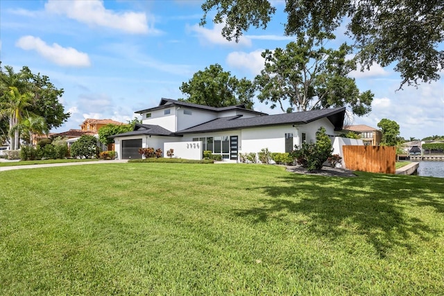 3956 Versailles Dr, Tampa, FL 33634 - view of front of home with a garage, stucco siding, driveway, and a shingled roof