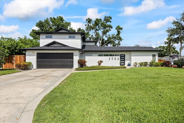 3956 Versailles Dr, Tampa, FL 33634 - view of front of home featuring stucco siding, driveway, and a garage