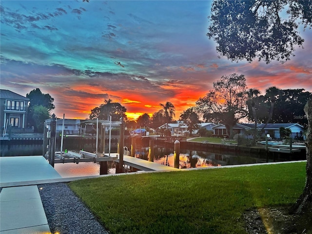 3956 Versailles Dr, Tampa, FL 33634 - dock area featuring boat lift, a yard, and a water view