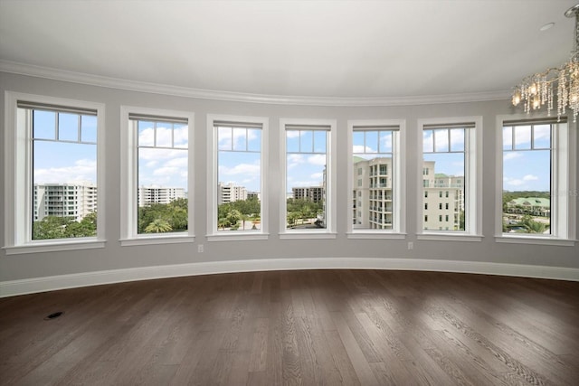 125 Belleview Blvd Unit 503, Belleair, FL 33756 - unfurnished sunroom featuring a chandelier, wood finished floors, plenty of natural light, and ornamental molding