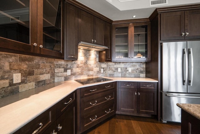 125 Belleview Blvd Unit 503, Belleair, FL 33756 - kitchen featuring freestanding refrigerator, black electric cooktop, under cabinet range hood, light countertops, and dark brown cabinetry