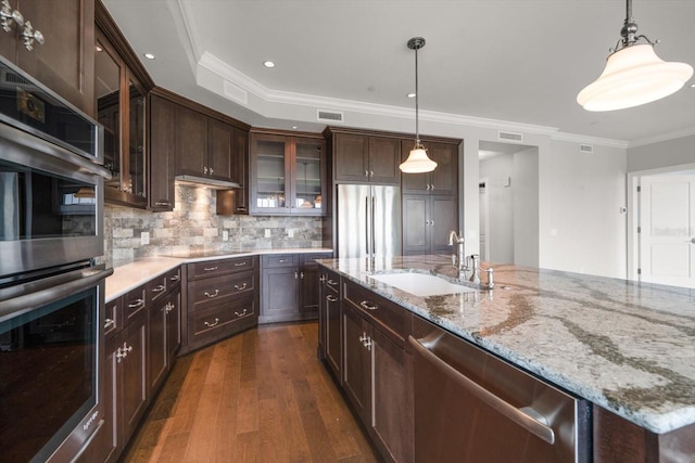 125 Belleview Blvd Unit 503, Belleair, FL 33756 - kitchen featuring appliances with stainless steel finishes, dark wood-type flooring, crown molding, glass insert cabinets, and dark brown cabinetry