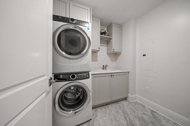 125 Belleview Blvd Unit 503, Belleair, FL 33756 - laundry room with estacked washer and dryer, electric panel, cabinet space, and light marble finish flooring