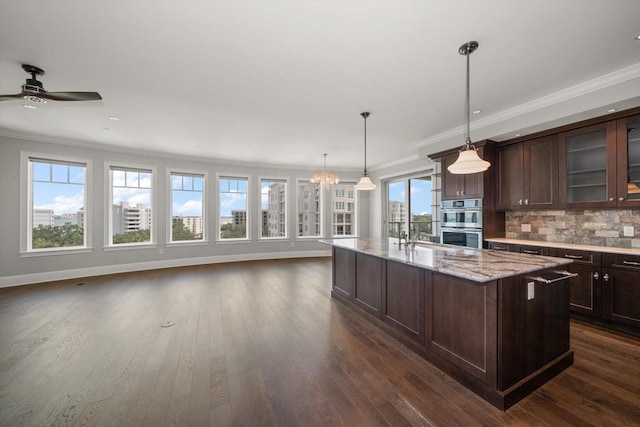 125 Belleview Blvd Unit 503, Belleair, FL 33756 - kitchen with double oven, crown molding, dark wood-style floors, open floor plan, and dark brown cabinets