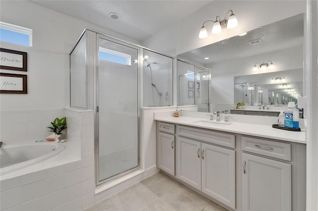 5611 Del Coronado Dr, Apollo Beach, FL 33572 - full bath featuring vanity, a stall shower, a garden tub, and tile patterned floors