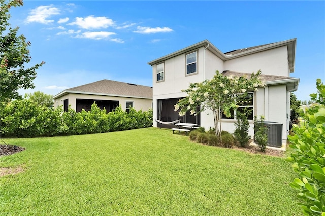 5611 Del Coronado Dr, Apollo Beach, FL 33572 - rear view of property featuring stucco siding and a yard
