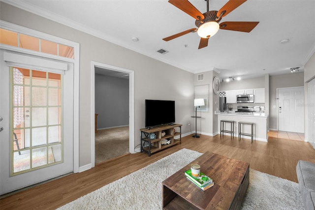 5000 Culbreath Key Way Unit 1-112, Tampa, FL 33611 - living area featuring crown molding, light wood-type flooring, and a ceiling fan