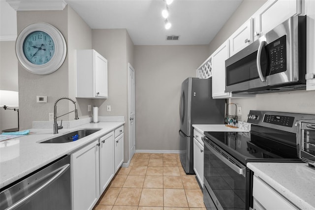 5000 Culbreath Key Way Unit 1-112, Tampa, FL 33611 - kitchen with stainless steel appliances, white cabinetry, and light tile patterned floors