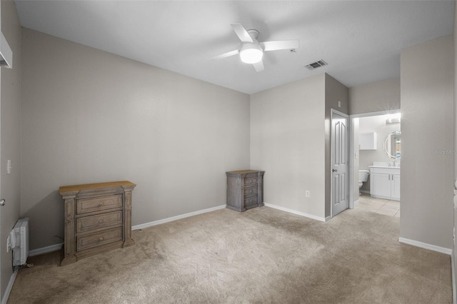 5000 Culbreath Key Way Unit 1-112, Tampa, FL 33611 - unfurnished bedroom featuring carpet flooring, connected bathroom, and ceiling fan