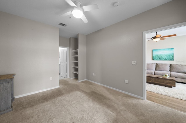 5000 Culbreath Key Way Unit 1-112, Tampa, FL 33611 - carpeted empty room featuring a ceiling fan, a smoke detector, and a fireplace