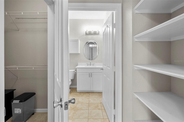 5000 Culbreath Key Way Unit 1-112, Tampa, FL 33611 - bathroom with vanity, a spacious closet, and tile patterned floors