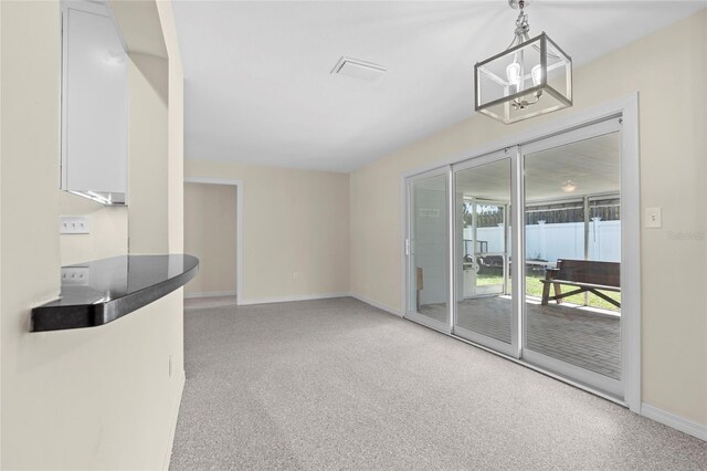 358 Highland Shores Dr, Ellenton, FL 34222 - unfurnished living room with baseboards and a chandelier