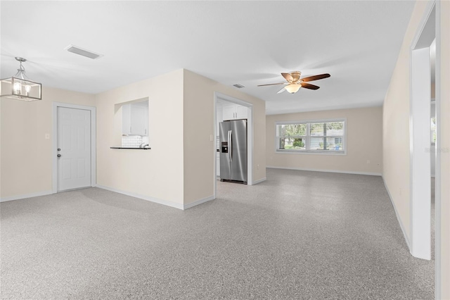 358 Highland Shores Dr, Ellenton, FL 34222 - unfurnished living room with a ceiling fan and a chandelier