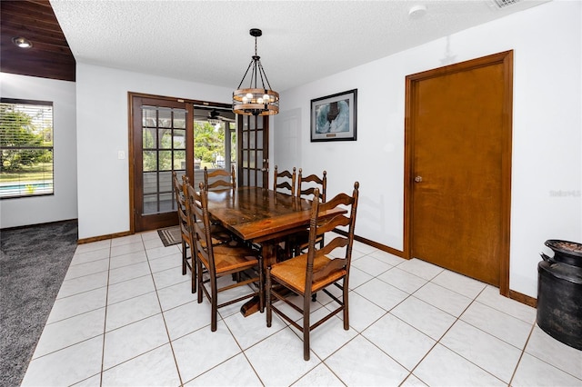 11203 Egret Nest Ct, Riverview, FL 33569 - dining area with healthy amount of natural light, a chandelier, light tile patterned floors, and a textured ceiling