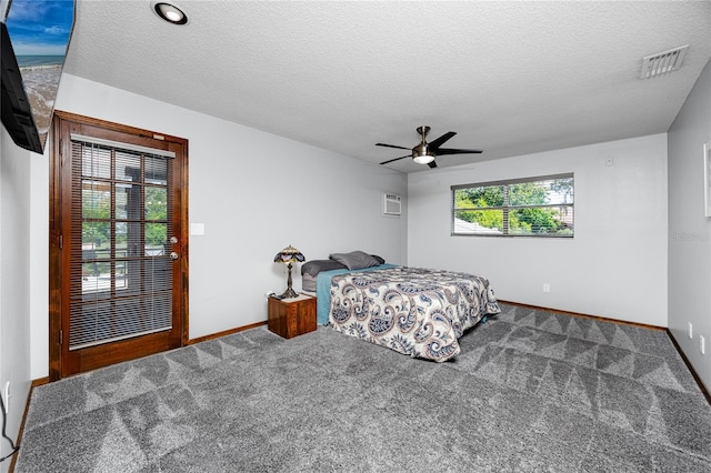 11203 Egret Nest Ct, Riverview, FL 33569 - carpeted bedroom with a ceiling fan, a textured ceiling, and a wall mounted air conditioner
