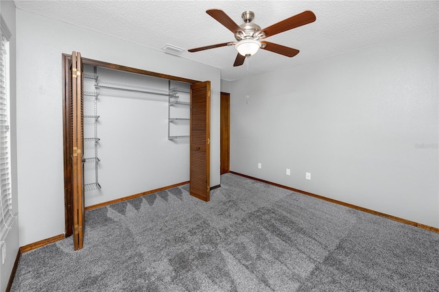 11203 Egret Nest Ct, Riverview, FL 33569 - unfurnished bedroom featuring carpet flooring, a closet, a textured ceiling, and a ceiling fan