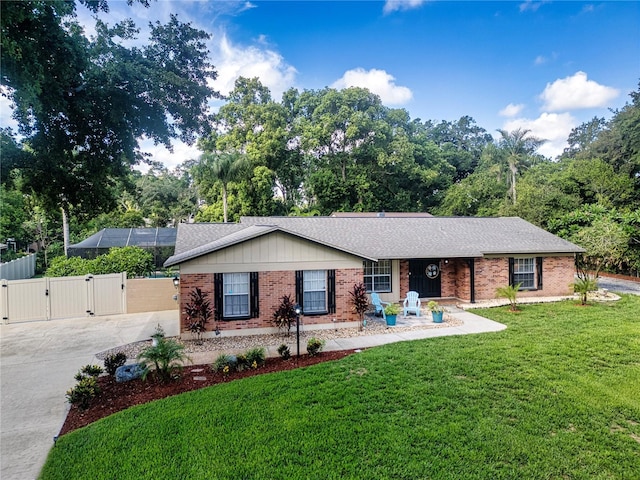 4205 Helene Pl, Valrico, FL 33594 - ranch-style house featuring a gate, brick siding, driveway, and roof with shingles