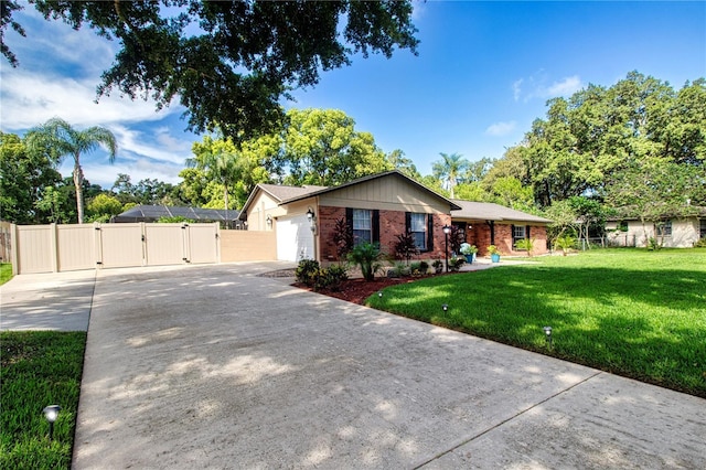 4205 Helene Pl, Valrico, FL 33594 - ranch-style home with a gate, concrete driveway, brick siding, and an attached garage
