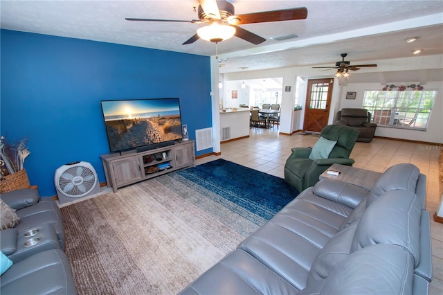 4205 Helene Pl, Valrico, FL 33594 - living room featuring a ceiling fan, a textured ceiling, and light tile patterned floors