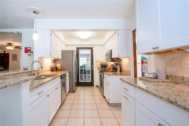4205 Helene Pl, Valrico, FL 33594 - kitchen featuring stainless steel appliances, light tile patterned flooring, white cabinets, and tasteful backsplash