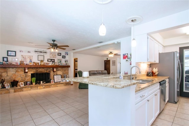 4205 Helene Pl, Valrico, FL 33594 - kitchen with a ceiling fan, light tile patterned floors, open floor plan, and white cabinets