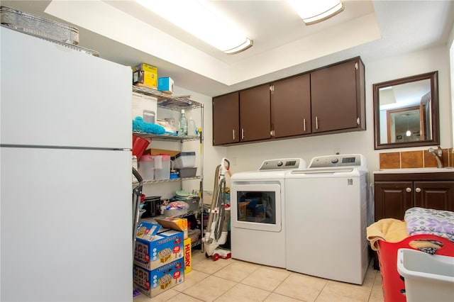 4205 Helene Pl, Valrico, FL 33594 - washroom with cabinet space, washer and clothes dryer, and light tile patterned flooring