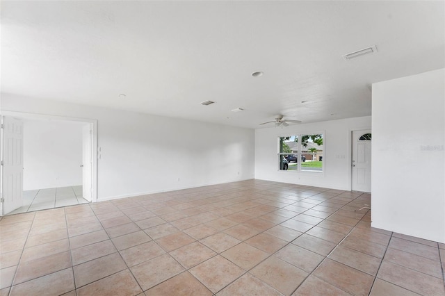 1041 SE Spinnaker Ave, Saint Lucie West, FL 34983 - empty room with light tile patterned floors and a ceiling fan