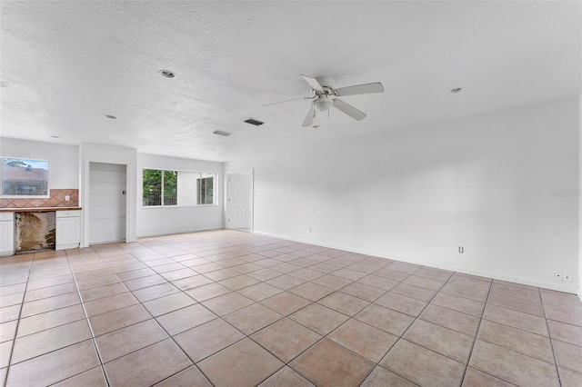 1041 SE Spinnaker Ave, Saint Lucie West, FL 34983 - unfurnished living room featuring ceiling fan and light tile patterned floors