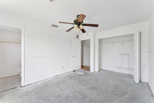 1041 SE Spinnaker Ave, Saint Lucie West, FL 34983 - unfurnished bedroom with a closet, connected bathroom, unfinished concrete flooring, and a ceiling fan