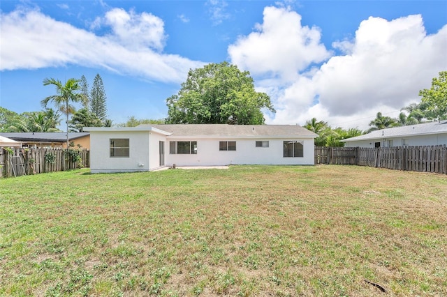 1041 SE Spinnaker Ave, Saint Lucie West, FL 34983 - back of property with a fenced backyard and stucco siding